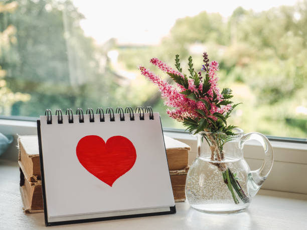 istock Notepad and painted heart. Daylight. Close-up, indoors 1477564449