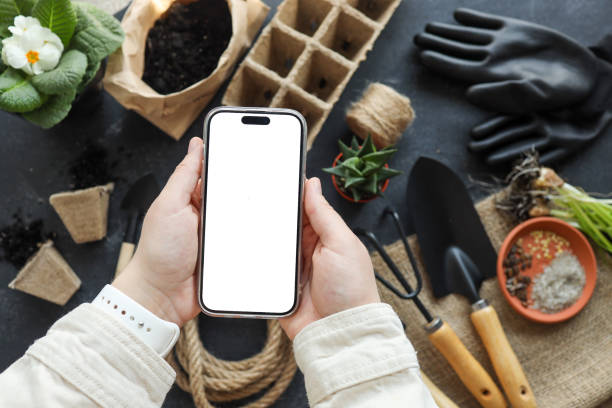istock Phone with an isolated screen for your text on the background of garden tools 1477565754