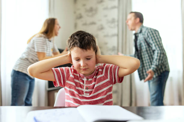 istock Sad child covers his ears with his hands during an argument between his parents 1477566209