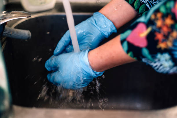 istock hands in latex gloves washed under running tap water 1477566483