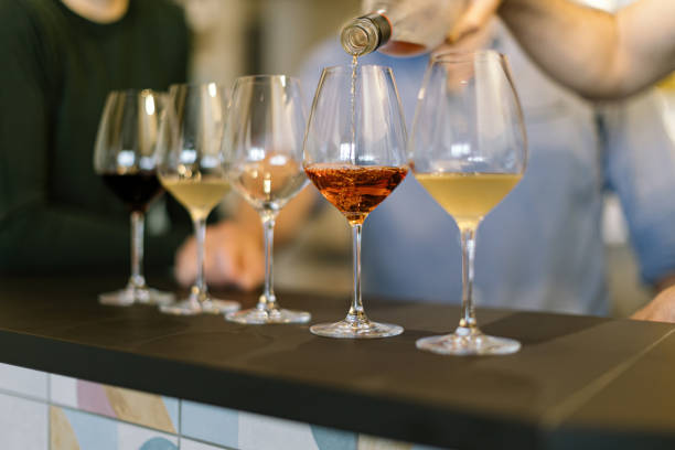 istock pouring wine on glasses - preparing wine tasting 1477567308