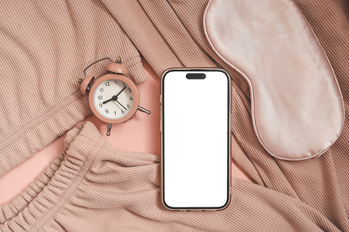 Phone with an isolated screen on the background of home clothes, a place for your text