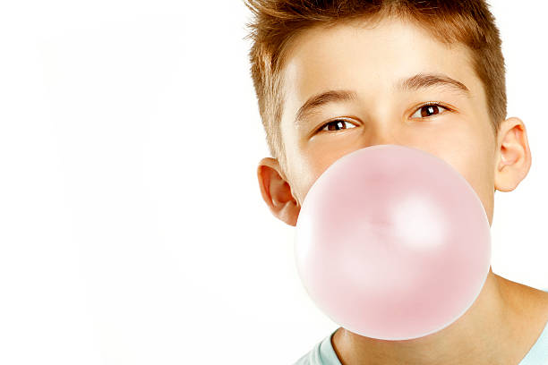 boy make bubble with chew boy make bubble with chew on white background chewy photos stock pictures, royalty-free photos & images