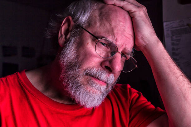 istock Sad Depressed Senior Man Looking Down With Hand on Head 1477571175