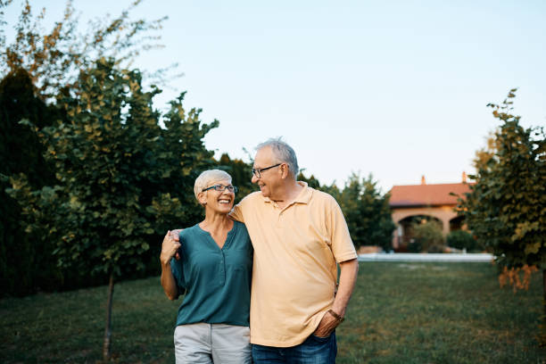 istock Embrace senior couple enjoying in a walk through their backyard. 1477571438