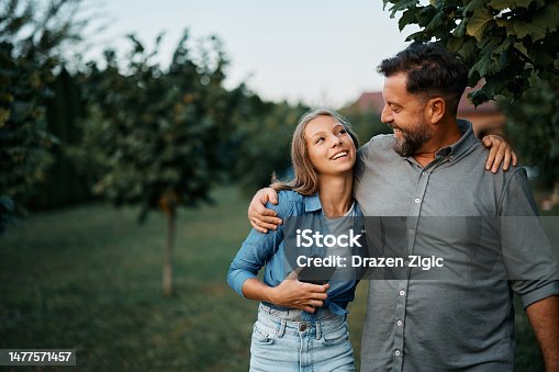 istock Happy man talking to his teenage daughter in the backyard. 1477571457