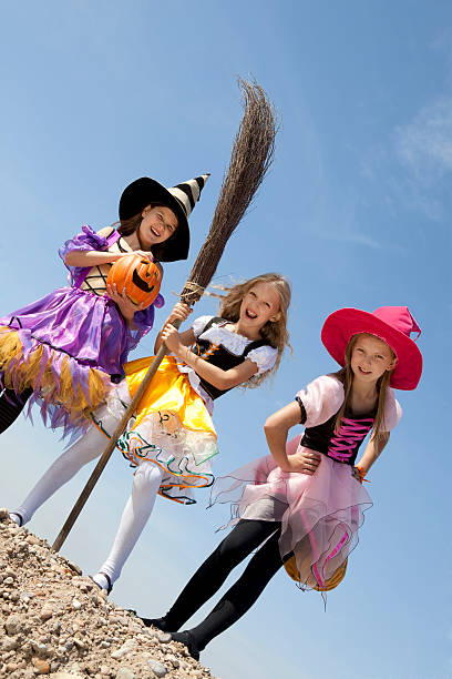 istock Three Cute Little Witches Standing with Bags 147757214