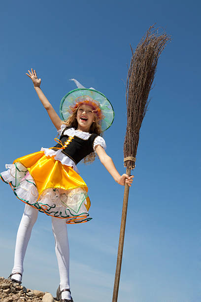 istock Happy Little Witch Standing with a Broom 147757246