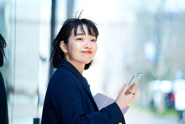 istock A woman holding a smartphone 1477572778