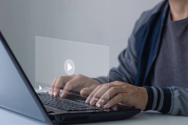 istock Businessman hands using laptop for streaming online, watching video on internet, live concert, show or tutorial. Concept about subscription based live digital stream or channels, multimedia player. 1477573068