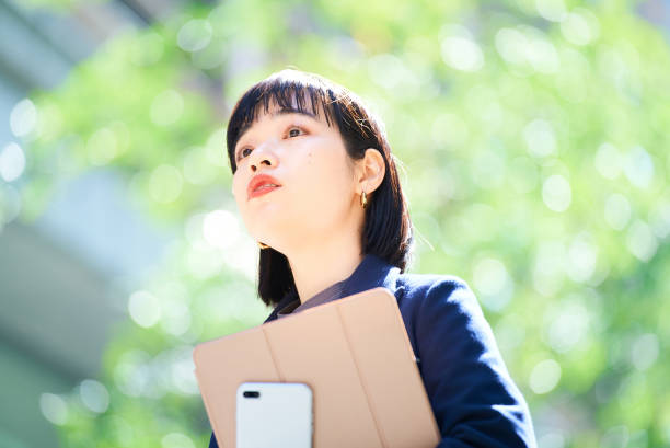istock A woman looking up at the sky (business woman) 1477573596