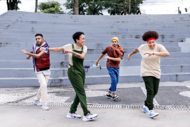 istock Cheerful group of friends practicing dance routines together 1477574467