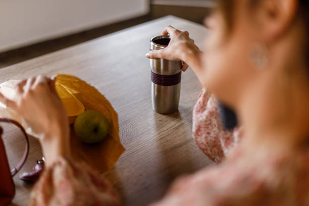 istock Young woman packing lunch and snack when getting ready to go to work 1477576122