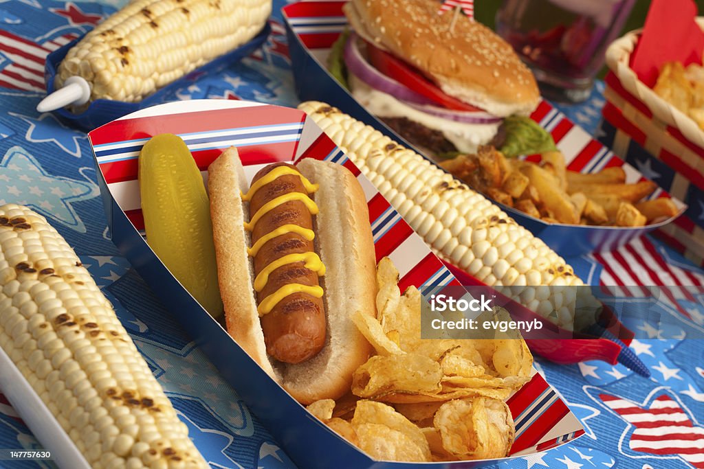 Picnic on 4th of July Hot dogs, corn and burgers on 4th of July picnic in patriotic theme Hamburger Stock Photo