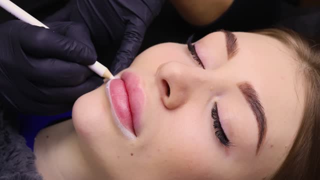Young girl on the procedure of permanent lip makeup