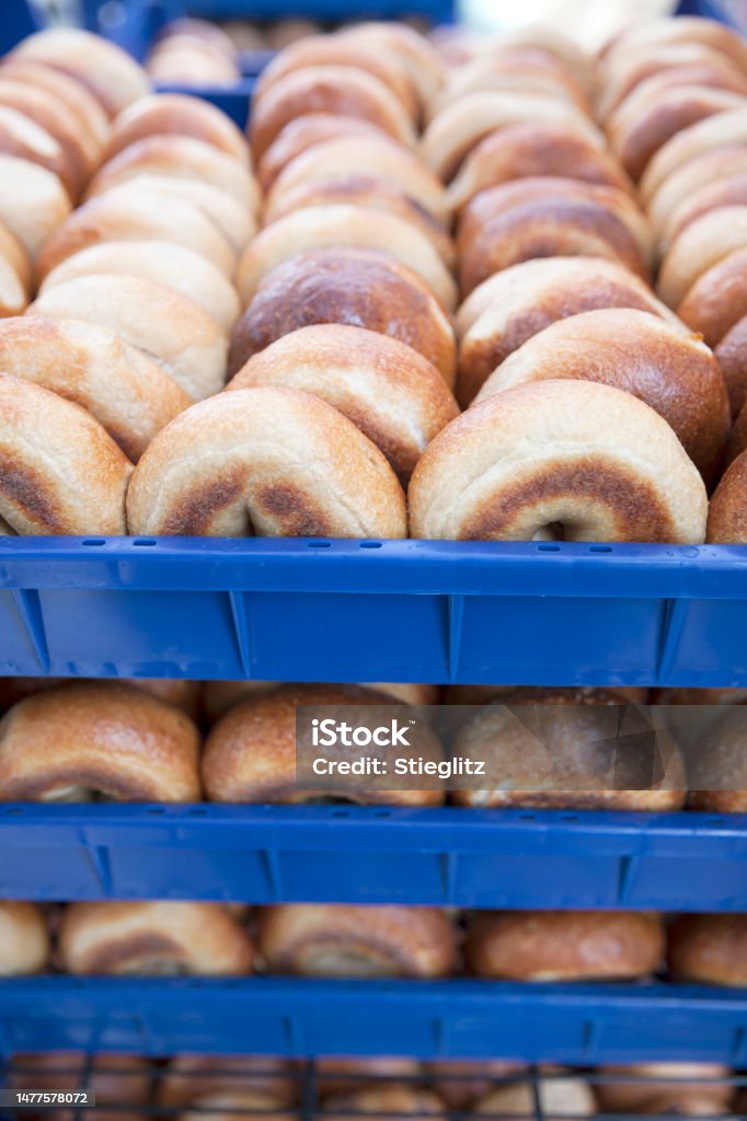 Bagels at a farmer's market Rows of freshly-baked bagels in blue crates for sale at a farmer's market. Abundance Stock Photo