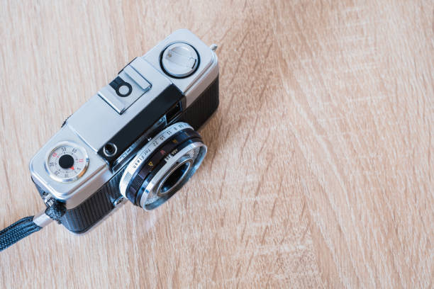 istock old roll system camera lying on wooden table, photographic roll system, photography theme, visual communication, top view 1477580717