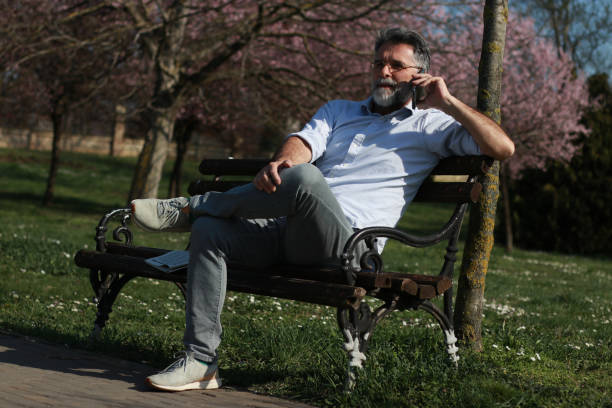 istock Mature man using phone for business fun internet love 1477581294