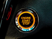 Engine Start or stop button in a conventional modern car. Car instrument panel, interior dashboard control.