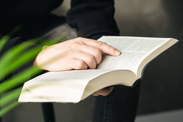 istock Christian man holds holy bible in hands, close up. 1477582084