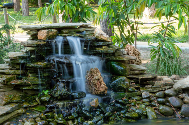 istock Artificial waterfall in a pond in the park 1477582379