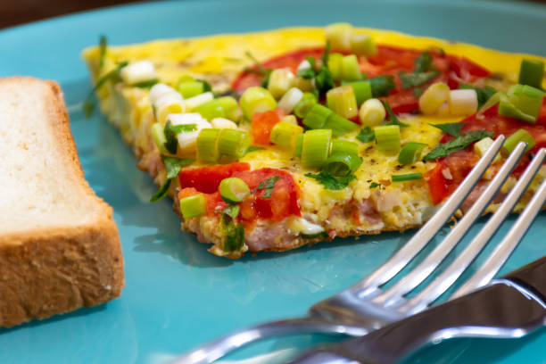istock Breakfast omelette with tomatoes and green onions 1477582790