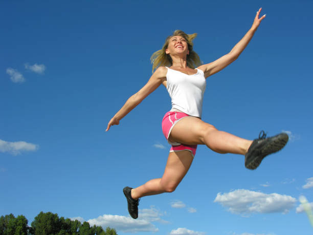 istock young athletic woman in a long jump 1477585582