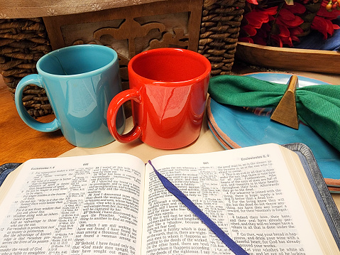 Open Bible on table with dishes for refreshments.  Preparations for an in home Bible Study.