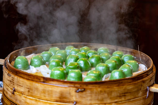 Fresh green dumplings in the steamer stock photo