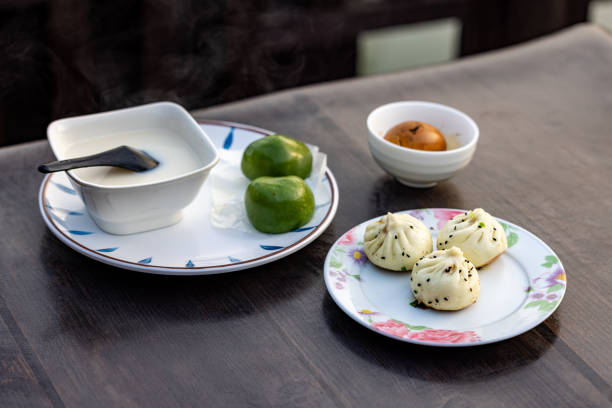 Traditional Chinese breakfast including soy milk, baozi, green dumplings and tea egg. stock photo
