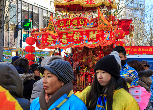 Paris, France-February 25,2018: Image of a traditional mobile shrine surrounded by people during the 2018 Chinese New Year parade in Paris.