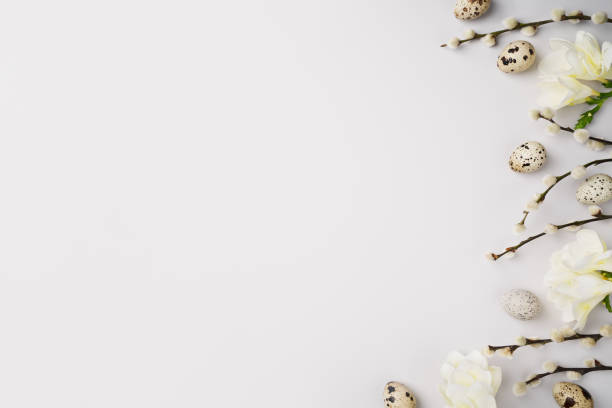 istock Happy Easter concept. Pussy willow branches, freesia flowers and natural quail eggs on light grey background. Festive blooming composition layout. Spring eco holiday. Top view, flat lay, copy space 1477588335
