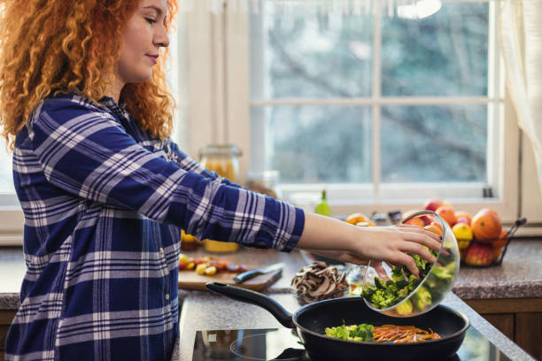 istock Woman steaming mixed vegetables in the kitchen 1477591161