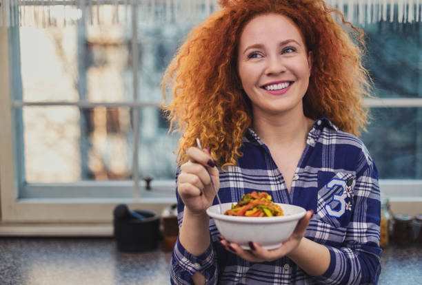 Woman eating a healthy vegetarian meal stock photo