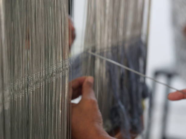 istock Selective focus traditional weaver is preparing yarn. Preparing the loom before starting to make woven ikat 1477591299