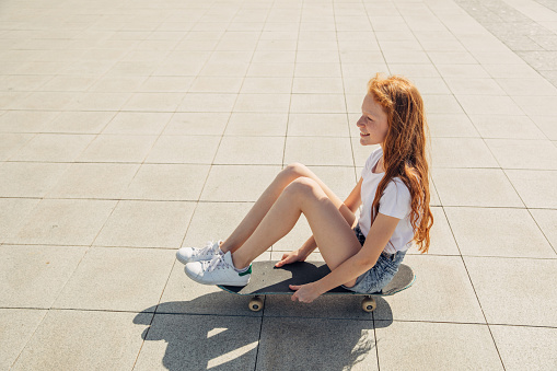 A young girl riding skateboard