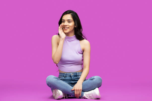 Photo portrait of young pretty girl gossiping wearing top isolated on purple background stock photo stock photo