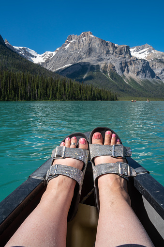 Womens feet wearing sparkly glitter sandals while on a canoe. Taken on Emerald Lake in Yoho National Park Canada