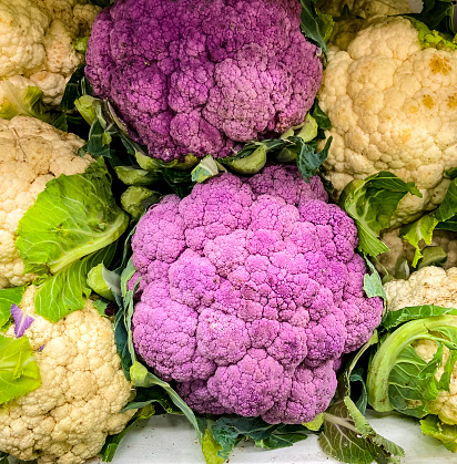 Close up view of healthy vegetables as purple cauliflower for retail sale in supermarket.