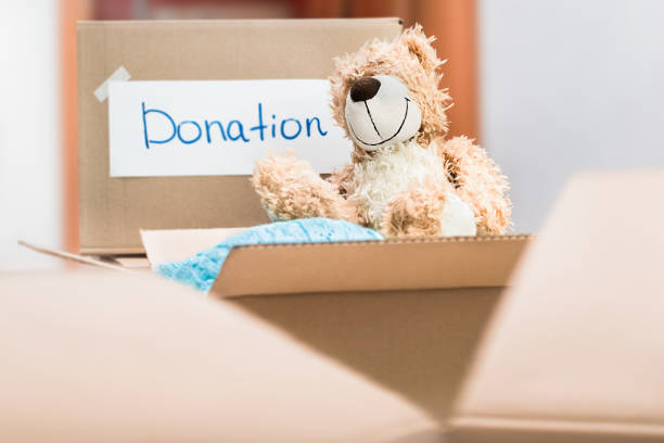 istock cardboard boxes with donations of clothes and toys 1477603817