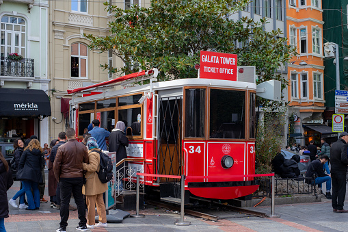 View of the famous red Taksim tramway used as Galata Tower Ticket Sales Office. 
The 10th of March, 2023. Istanbul.