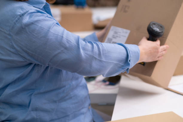 istock logistic shipping online orders concept. close up scanning barcode on package delivery, e-commerce 1477604740