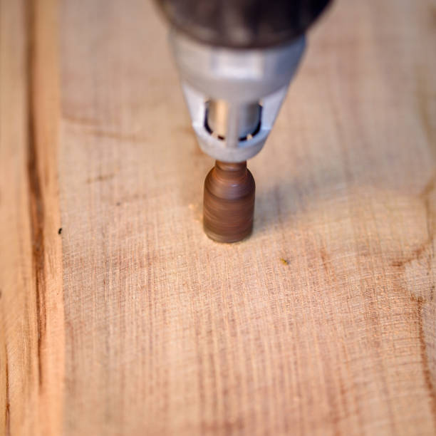 istock A screwdriver, tighten screw in wooden board 1477609128