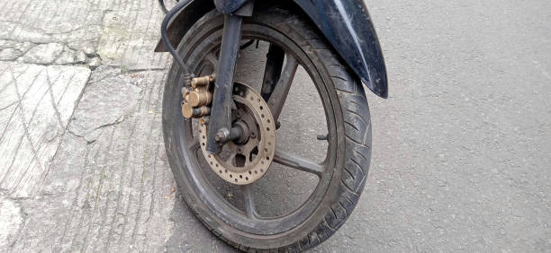 istock dirt bike front wheel on the road 1477609295