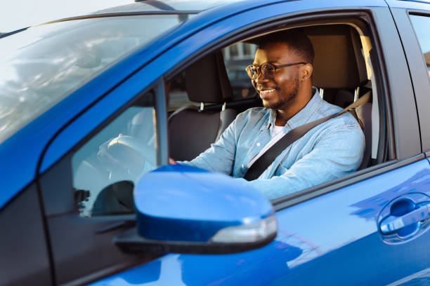istock Cheerful male driver in the car 1477609410