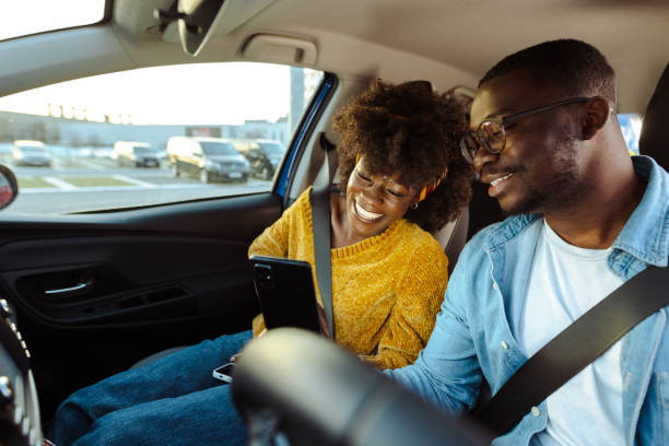 istock Cheerful African American couple using smart phone in car 1477609683