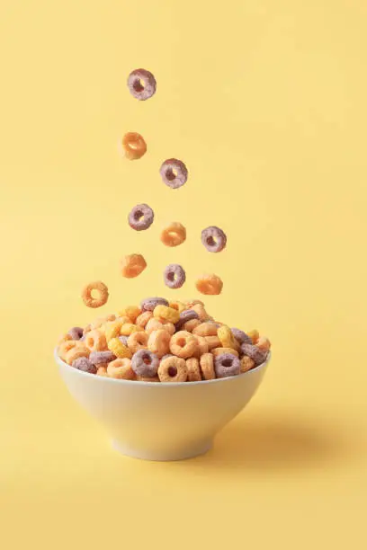 Cornflakes, Colorful corn rings in bowl with milk and spoon