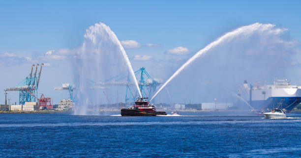 Norfolk, Virginia, USA - June 10, 2022: The fire ship Rosemary McAllister leads the Parade of Sail up the Elizabeth River to Waterside in Norfolk Virginia.