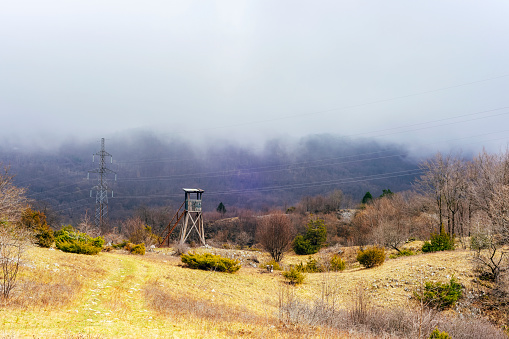 Hunting tower in the foggy mountains. Ucka Nature Park, Croatia.