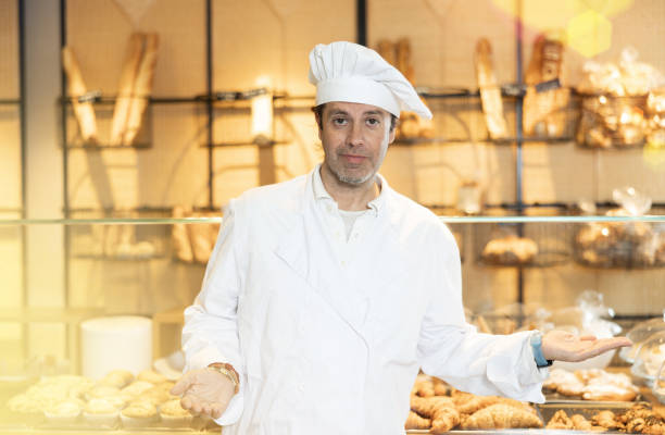 Successful baker inviting to bakeshop, presenting baked products